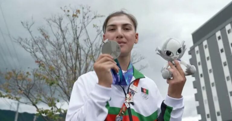 Afghan cyclist Fariba Hashimi displaying her silver medal from the 2026 Asian Games
