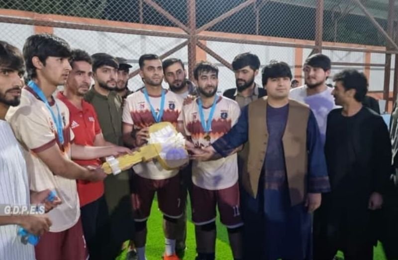 Tariq Shahid High School football players receive the championship trophy in Ishkamish district