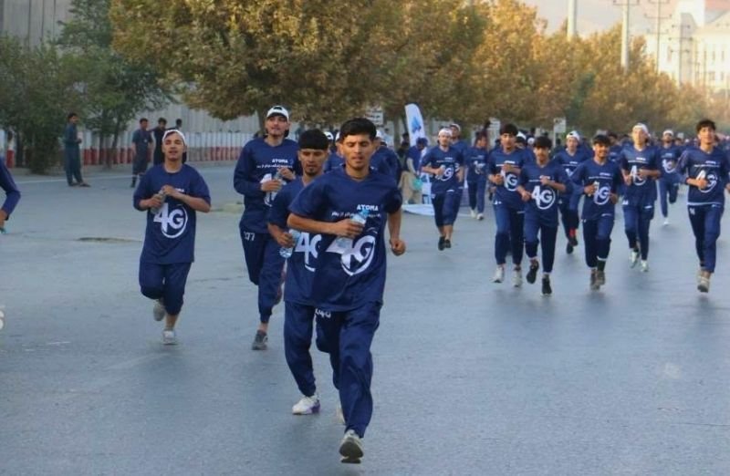 Athletes running in a 10-kilometre road race between Darulaman and Ghazi Stadium in Kabul