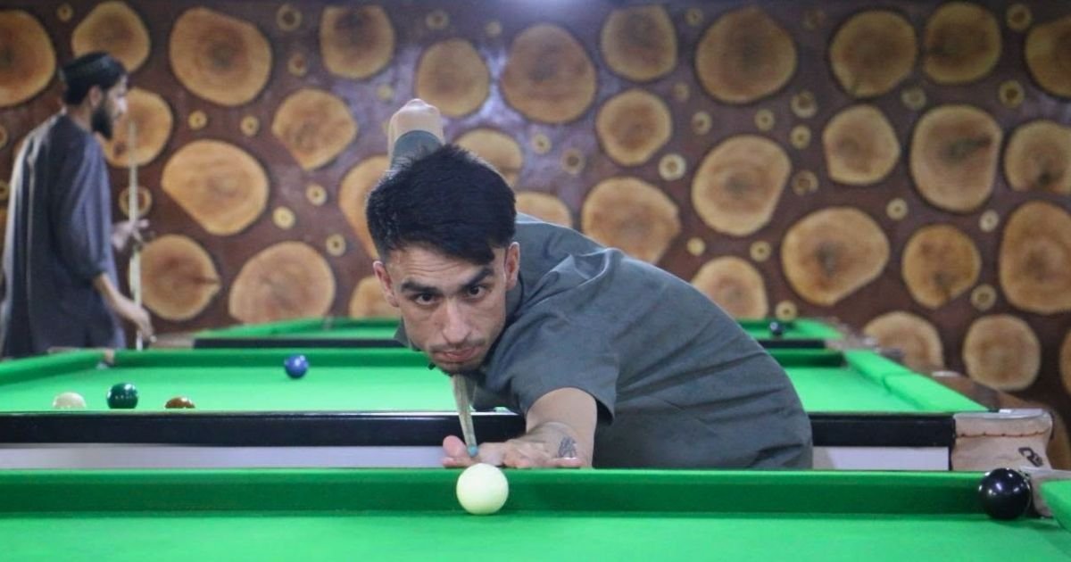 Snooker players competing in a tournament involving 90 athletes from 30 clubs in Kabul