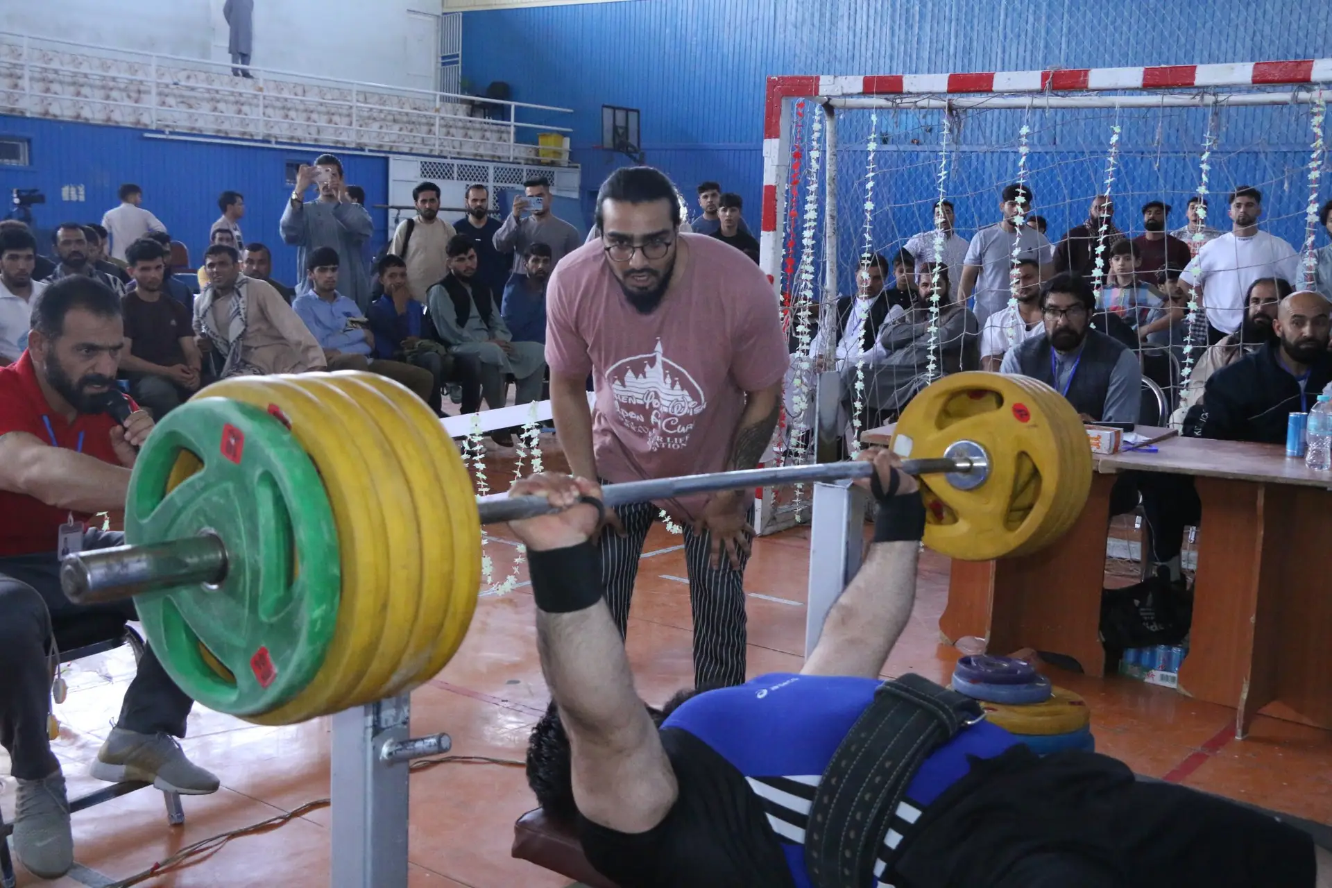 Afghan athlete competing in a powerlifting event in Kabul