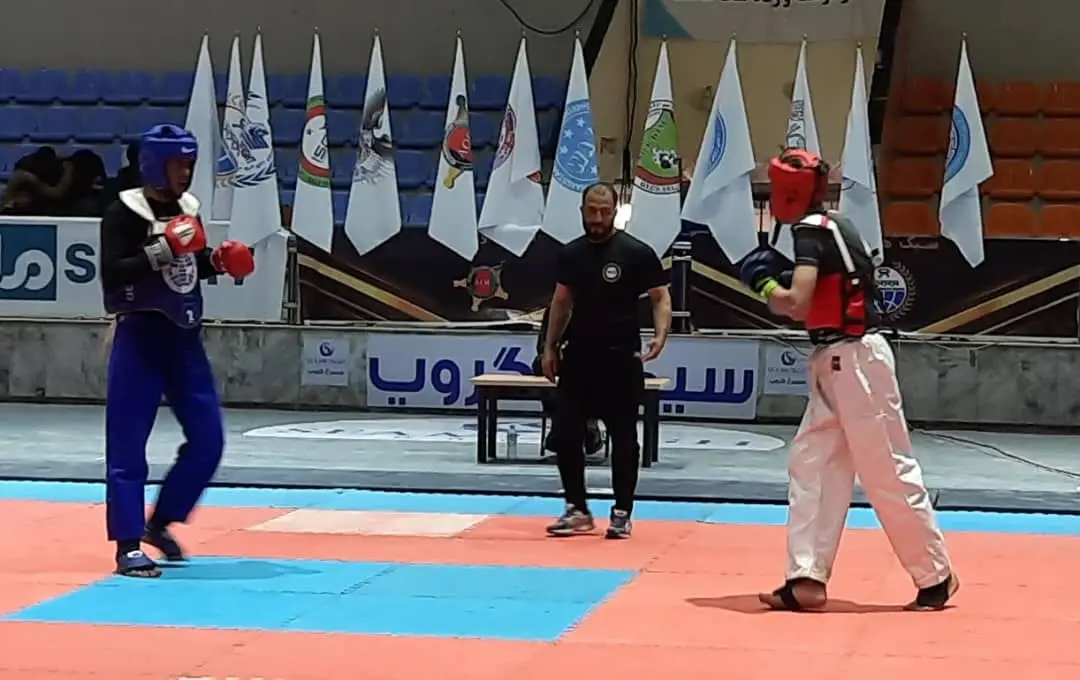 Martial arts athletes competing at an indoor Afghan sports competition