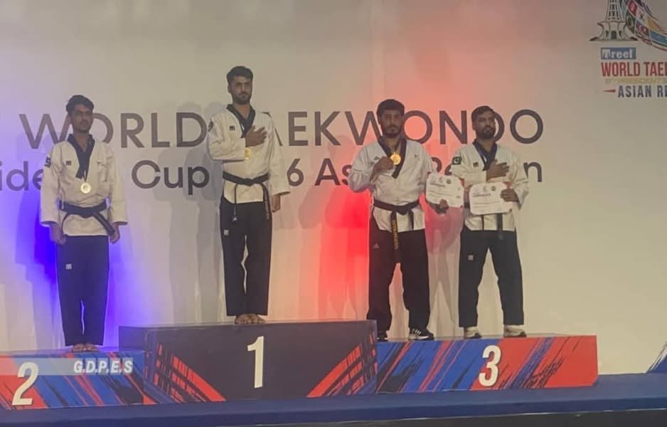 Afghan taekwondo athlete Mohammad Gul Mohammadi stands on the bronze-medal podium at the 2026 World Taekwondo President’s Cup Asian Region in Lahore