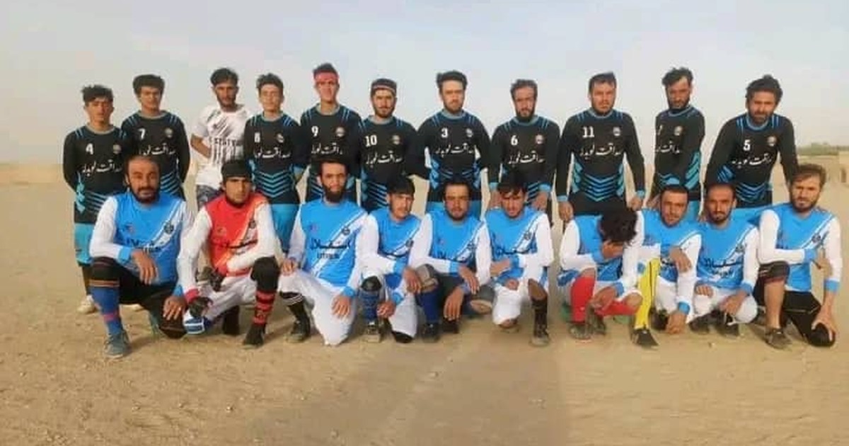 Footballers pose for a group photograph at a tournament in Gilan district, Ghazni