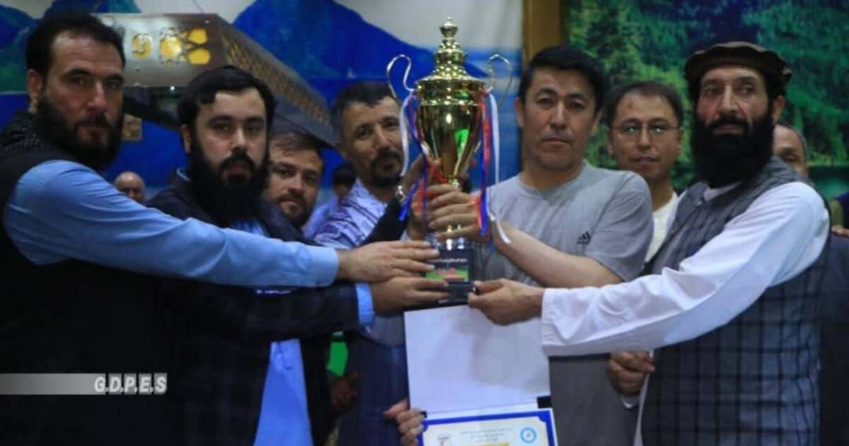 Zakaria Sherzad and snooker officials hold the winners’ trophy after a Kabul tournament