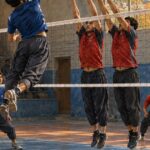 Editorial illustration of a volleyball match, created for the report on Etihad Dara’s 3–0 victory over Jawanan Rukha in Panjshir. This is not a photograph of the actual match.